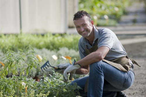 Professional gardeners wearing PPE while working in a Lewisham garden